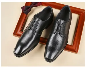 Macro detail of men's black leather Derby shoes featuring embossed texture and lace-up closure