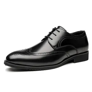 Classic black leather Brogue shoes with elegant wingtip carving on white background.