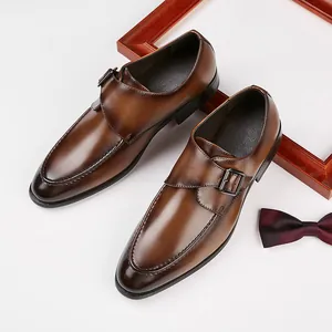 Classic brown monk strap leather dress shoes for men in a stylish business setting