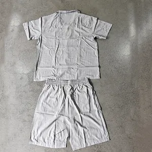 Detailed flat lay view of a grey men's short sleeve shirt and matching shorts casual set