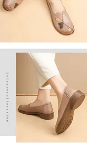Close-up view of comfortable middle-aged women's flat leather shoes with butterfly embroidery