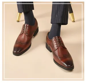 Close-up of brown leather wingtip brogue shoes with elegant decorative perforations