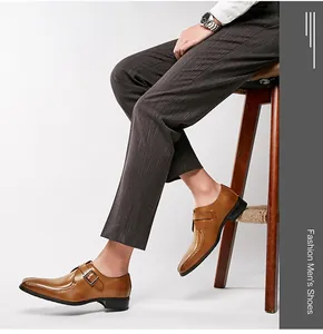 Side profile of brown leather monk strap dress shoes with a metallic buckle and pointed toe