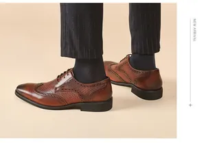 Detail of brown leather Brogue shoes with intricate perforated carving patterns