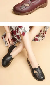 Close-up of comfortable middle-aged women's soft leather flat shoes with floral embroidery