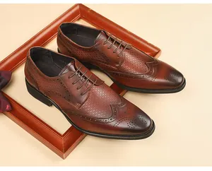 Close-up detail of brown leather brogue derby shoes with intricate carved patterns
