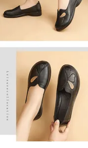 Detailed view of comfortable black leather flats with butterfly embroidery for women