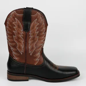 Close-up detail of a classic black and brown western cowboy boot with white embroidery