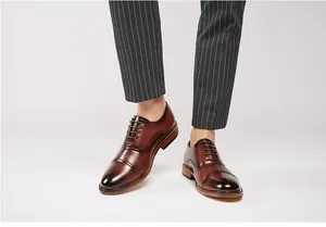Classic men's brown leather Oxford shoes with a polished cap-toe design for business formal wear.