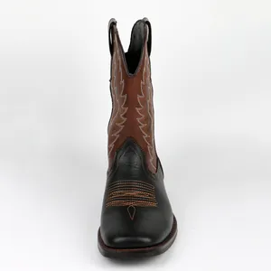 Front view detail of bi-color Western cowboy boots with decorative stitching