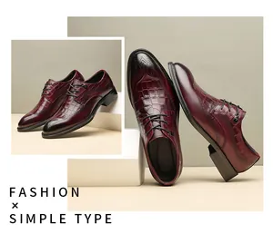 Close-up of burgundy leather dress shoes showing crocodile pattern and classic Brogue carving