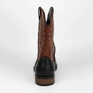 Rear view of brown and black leather Western cowboy boots with white stitching.
