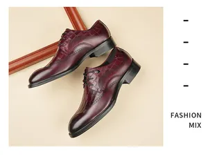 Detail of burgundy men's leather Derby shoes with crocodile pattern and brogue carving.
