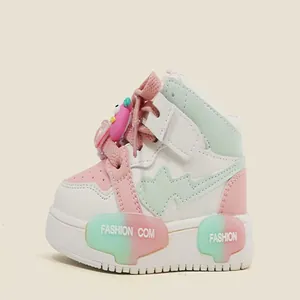 Detailed side view of cute pink and mint green toddler sneakers with heart motif