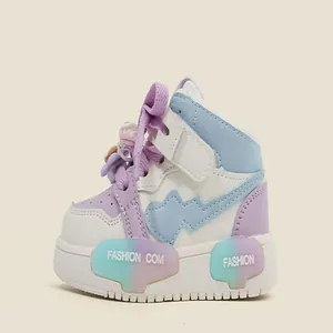 Detailed side view of pastel color-block high-top sneakers for toddler girls.