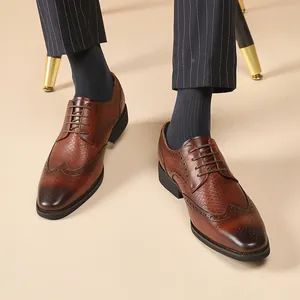 Classic brown leather Brogue dress shoes for men with detailed intricate carved patterns