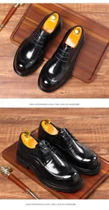 Detailed view of black leather dress shoes with crocodile texture on a wooden tray