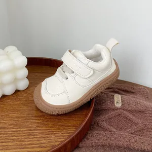 Cream beige toddler walking shoes with soft sole and breathable faux leather material
