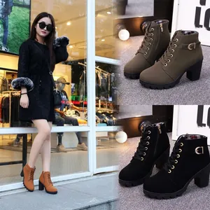 Detailed macro view of women's lace-up ankle boots featuring chunky heels and platform soles