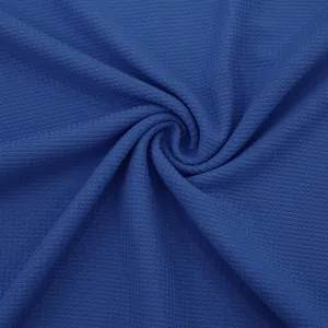 Primer plano de tela azul de punto gofre que muestra la textura y el pliegue espiral