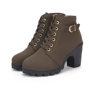 Side view of olive green lace-up platform ankle boots with golden buckle detail