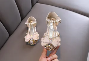 Detailed view of sparkling rhinestone princess shoes for girls with pearl strap and elegant bow