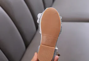 Detail of durable rubber sole on silver glittery girl's princess shoe with size 27 mark