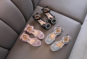 Detailed view of girl's princess shoes with sparkly rhinestones and cute bunny ears