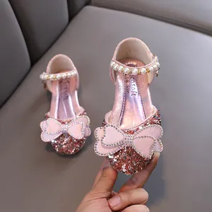 Elegant pink glitter princess shoes for girls with rhinestone bow and pearl strap detail