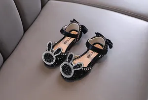 Detailed view of black girls princess shoes featuring sparkling rhinestone bunny decoration