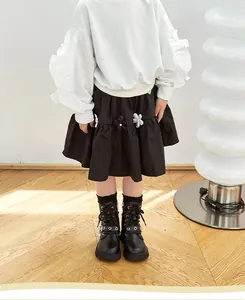 Detailed view of black children's Martin boots with star buckles and side zipper
