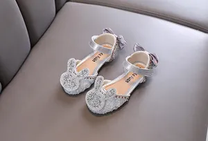 Close-up of girls' silver princess shoes with rhinestone bunny ears and bow