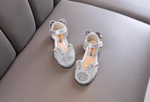 Detail showing silver rhinestone bunny design on girl's princess dance shoes.