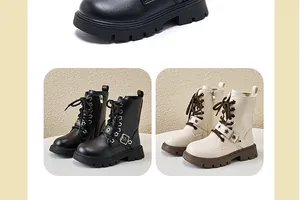 Detail view of stylish black and beige children's Martin boots with side zippers and floral buckles