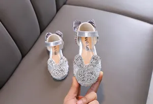 Macro view of silver girls' princess shoes featuring sparkling rhinestone bunny decoration
