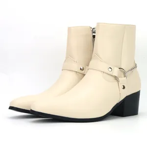 Detail of beige men's high heel boots with decorative metal chain and black block heel.