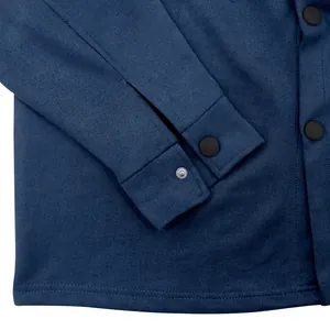Close-up of navy blue suede jacket showing matte snap buttons and sleeve cuff detail