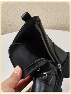 Close-up view of children's black Martin boot showing side zipper and inner lining detail