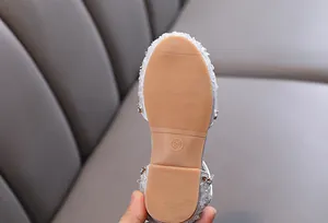 Close-up of the non-slip rubber sole on silver rhinestone princess shoes for girls