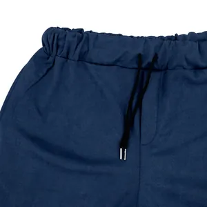 Close-up of navy blue suede pants featuring elastic waistband and black drawstring