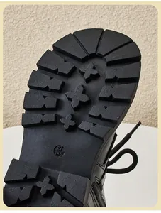 Close-up detail of durable anti-slip rubber sole for children's black Martin boots