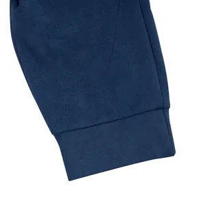 Close-up view of navy blue suede jacket cuff detail showing fine fabric texture and stitching