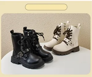 Detail view of children's Martin boots in black and beige with stylish buckles and zippers