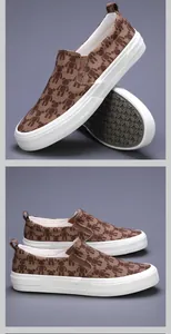 Detail view of men's casual canvas slip-ons with teddy bear pattern and thick white soles