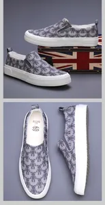 Men's casual slip-on canvas shoes featuring a trendy grey bear pattern and white sole
