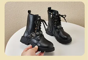Close-up view of black children's Martin boots with flower eyelets and functional side zipper