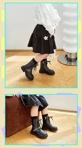 Detail showing black children's Martin boots with side zipper and star buckle decoration