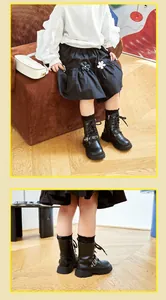Detailed view of black children's Martin boots with side zippers and buckles