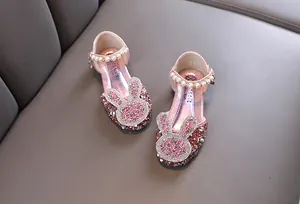 Detailed view of pink glittery princess shoes for girls featuring a rhinestone bunny design