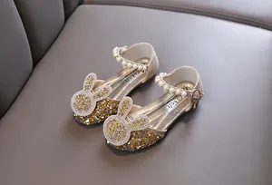 Detailed view of sparkling gold princess shoes for girls with cute bunny ear design
